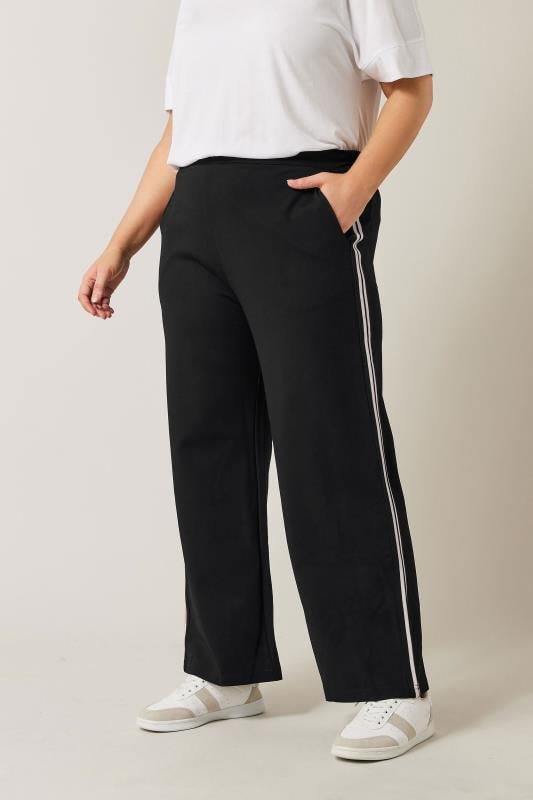 Black trousers with white stripe best sale