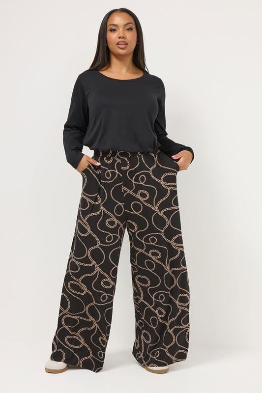 YOURS Plus Size Black Chain Print Wide Leg Trousers | Yours Clothing 1