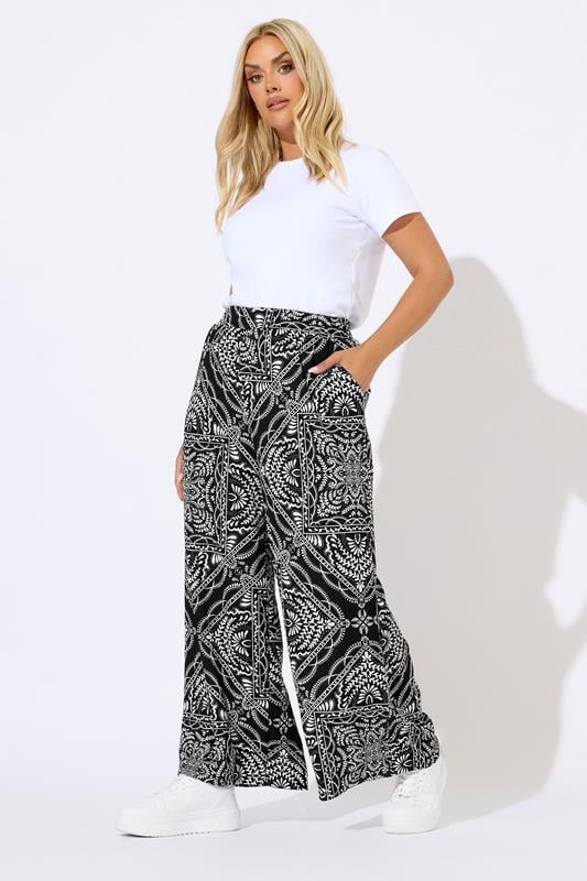 YOURS Plus Size Black Bandana Print Textured Wide Leg Trousers | Yours Clothing 1
