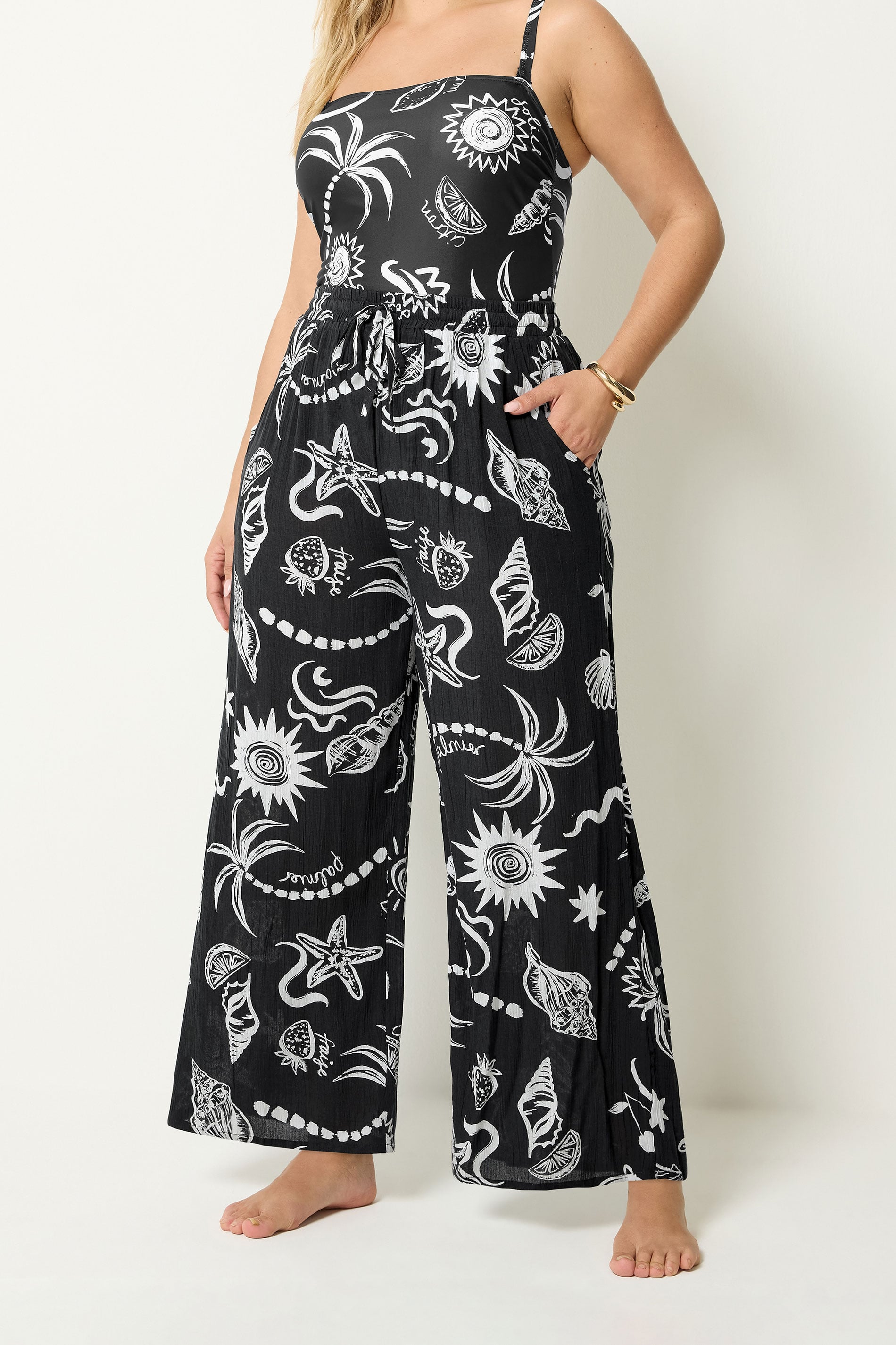 YOURS Plus Size Black Summer Print Crinkle Beachwear Wide Leg Trousers | Yours Clothing 1